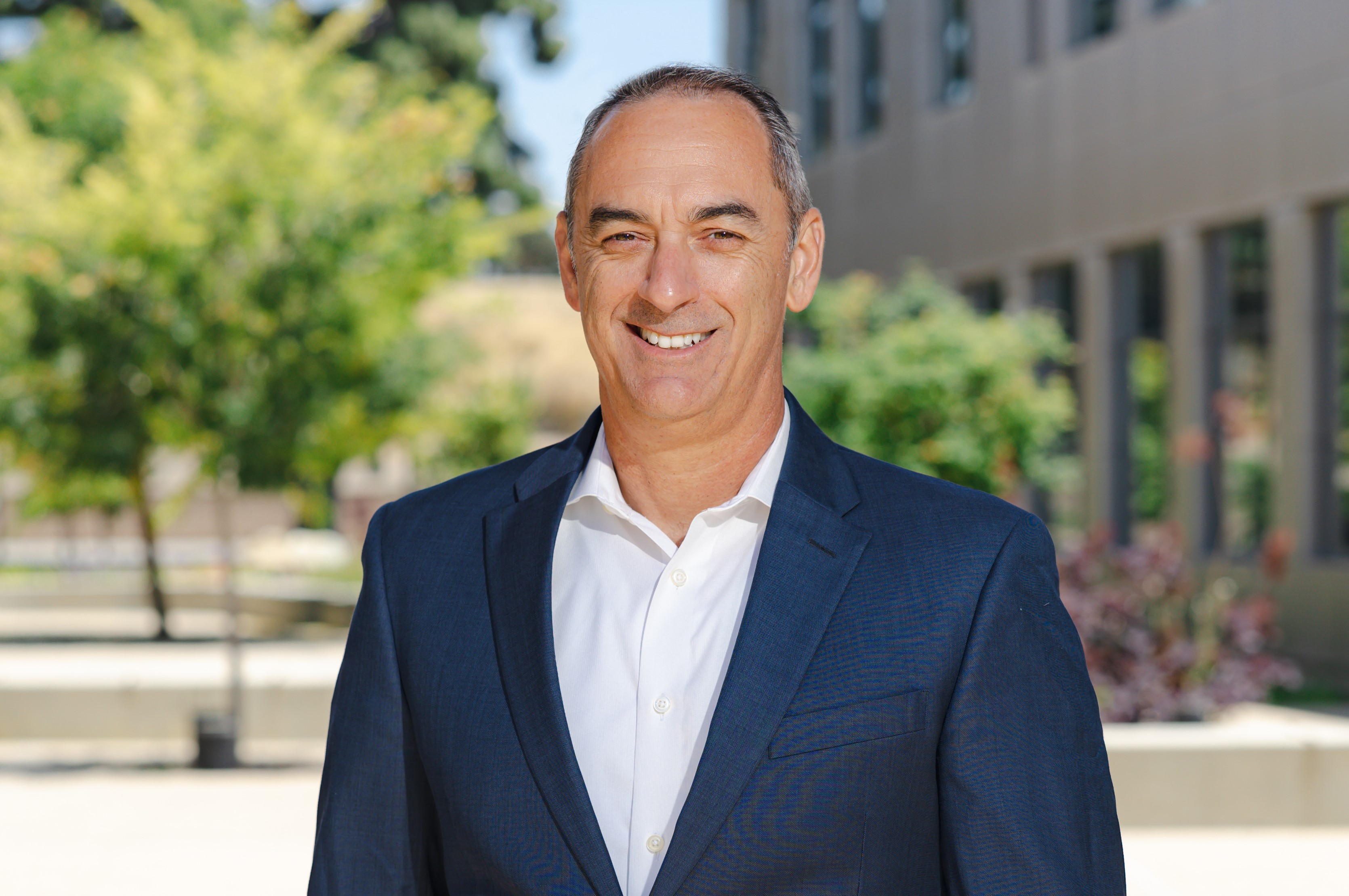 Dennis Curran stands outside the Hancock Student Services building.